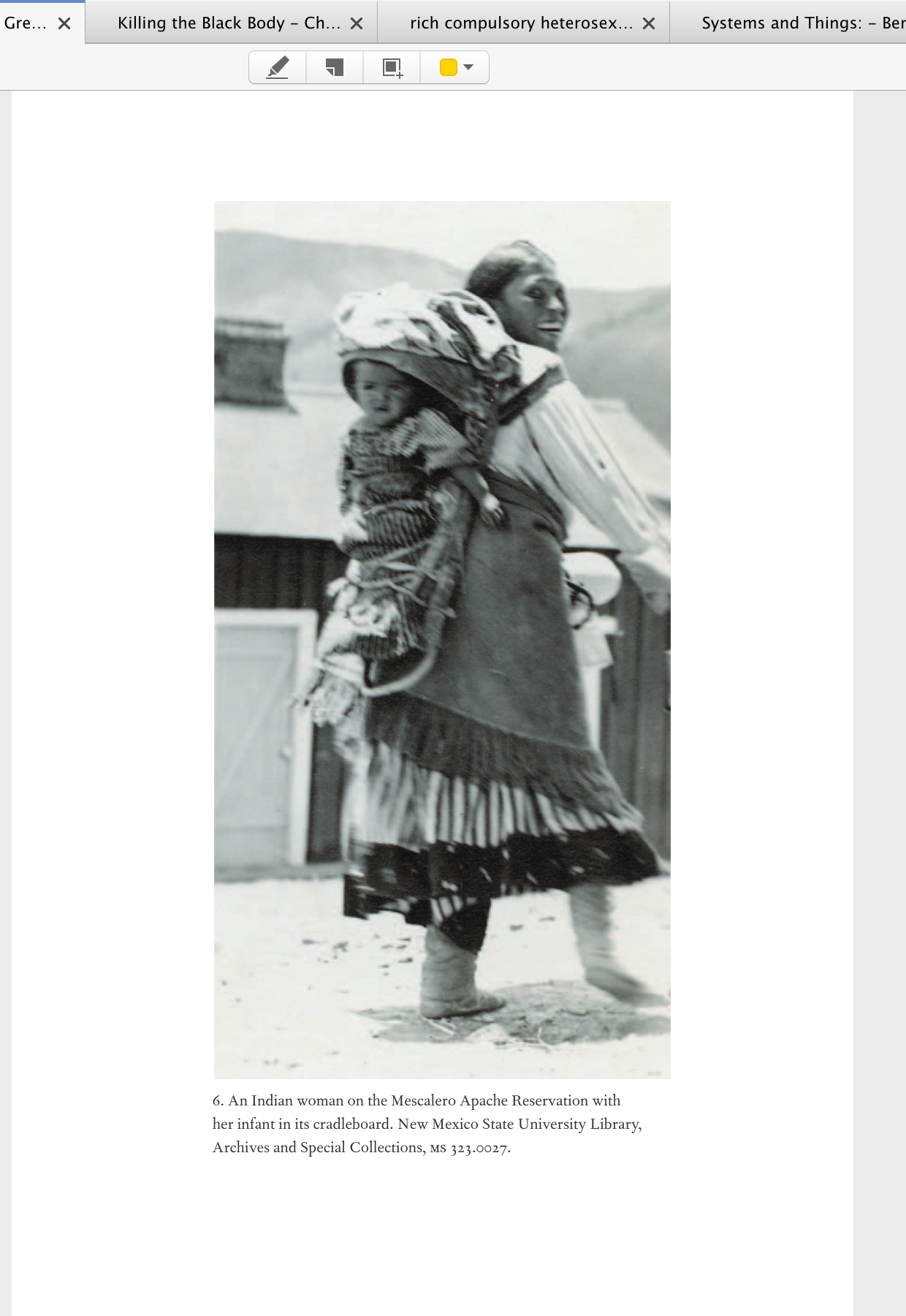 Indian Mescalero Apache woman carrying a cradleboard